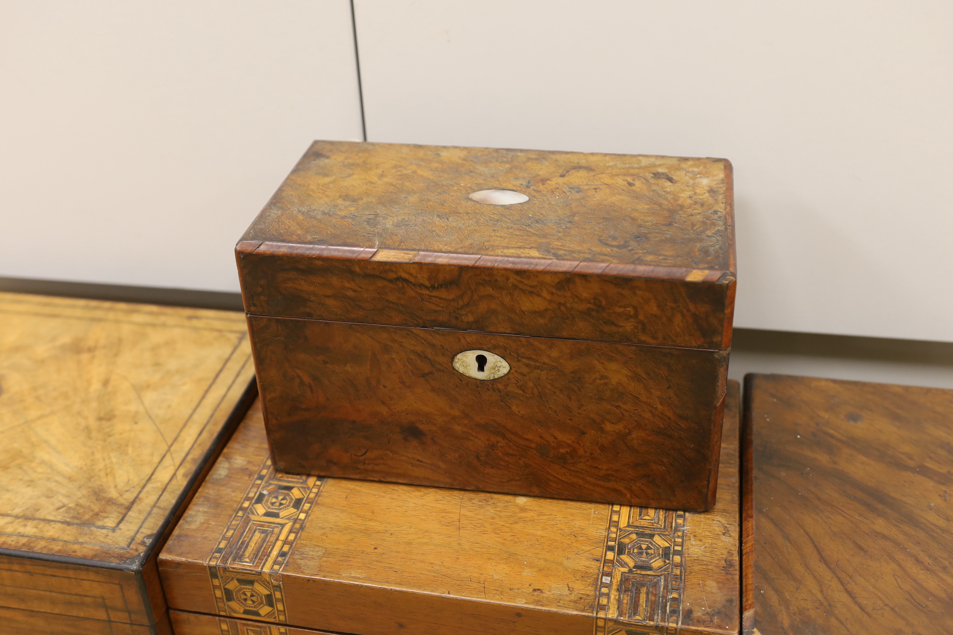 Three Victorian writing boxes and a tea caddy, largest 35cm wide, 15cm high, 24cm deep